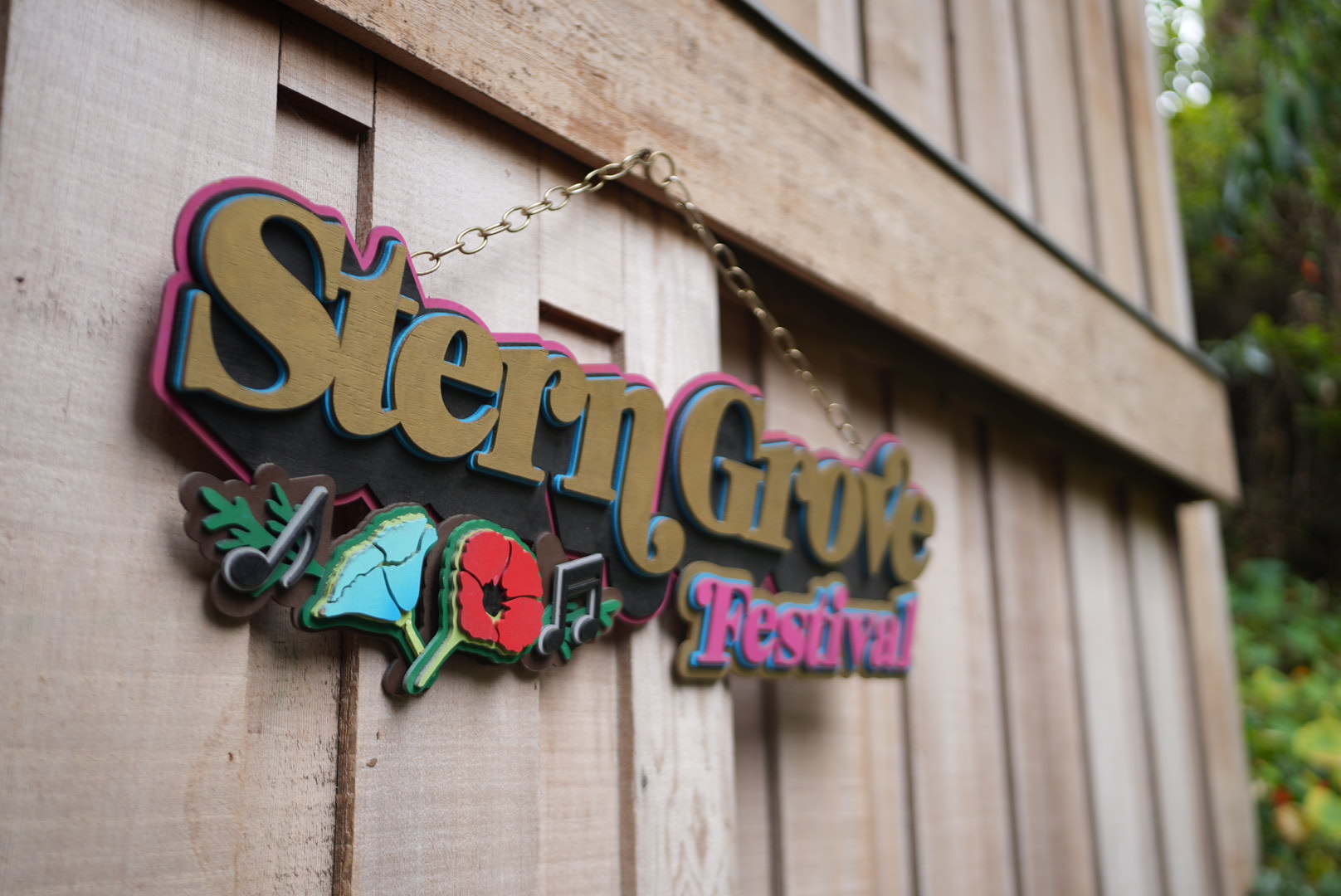 Hand-painted Stern Grove Festival sign hanging on a wooden wall