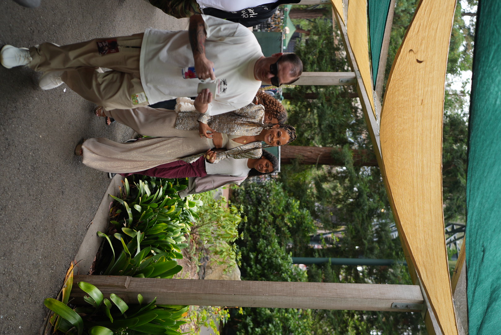 Goapele smiling as she walks through the Stern Grove grounds with her team